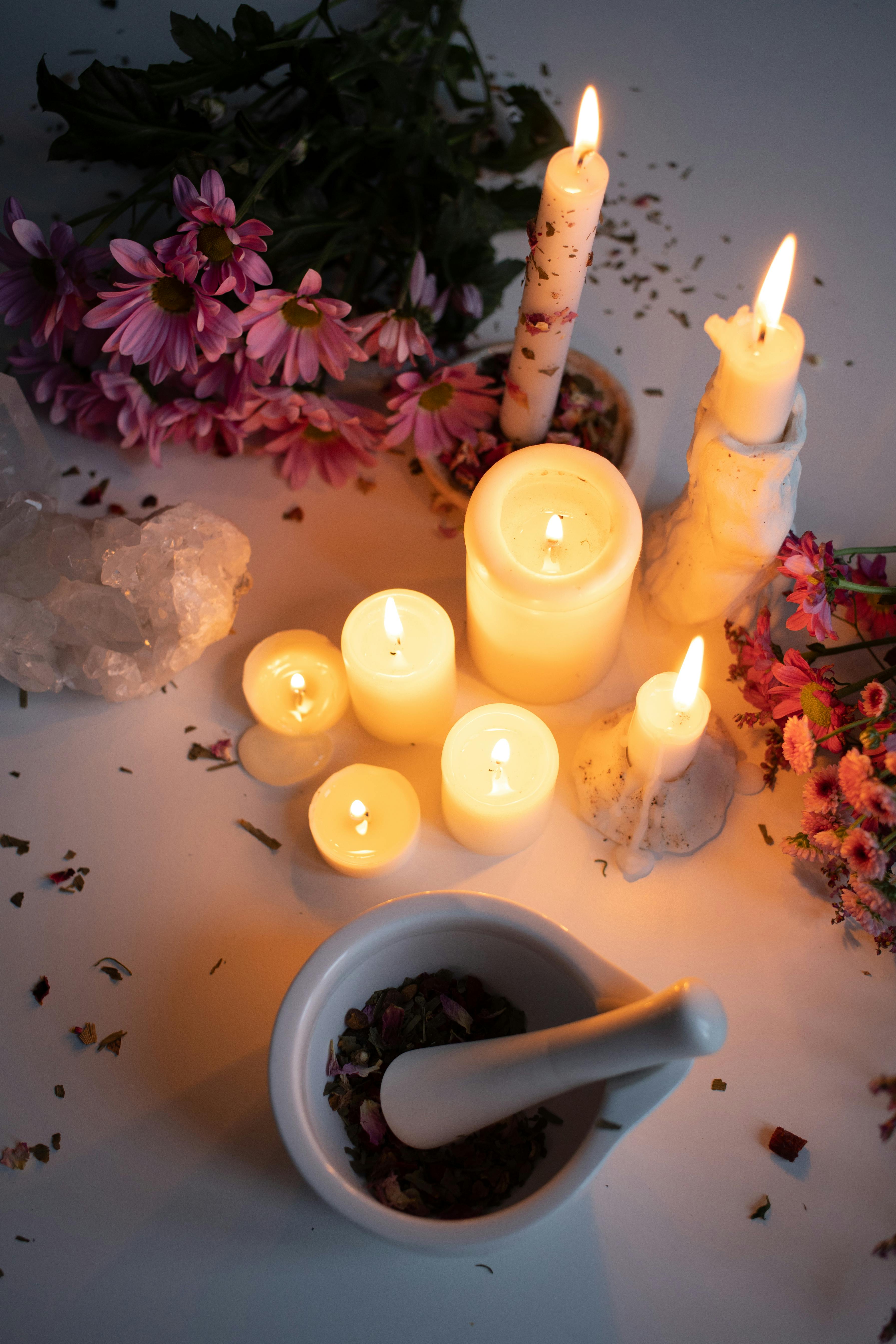  image that shows lighted candles around flowers 