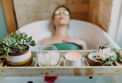  girl in the bath tup relaxing with candles