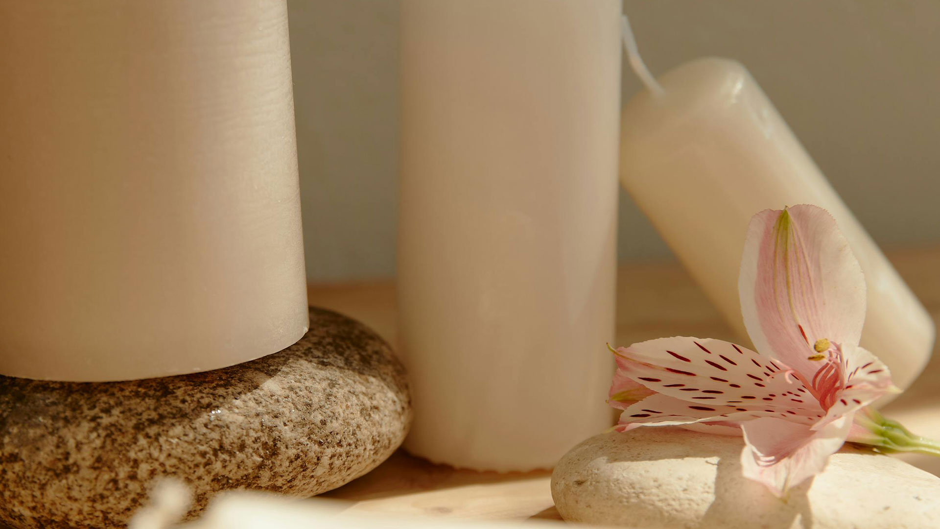 white candles with diffterent size in the sunlight 